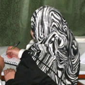 Photo of an Afghan woman writing